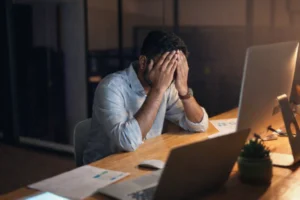 one man sitting in the office stressed by office environment.